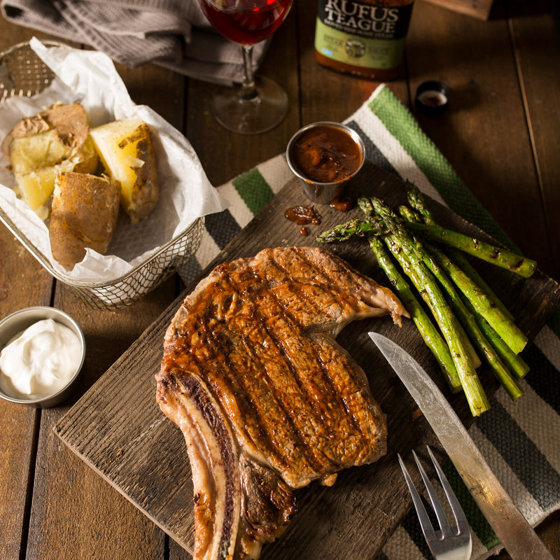 Seared steak and veggies on a cutting board.