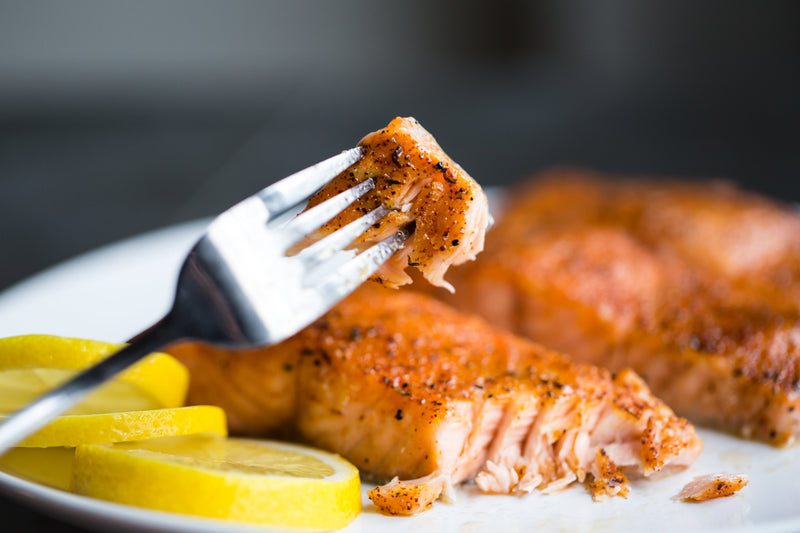 Succulent salmon and lemon wedges .